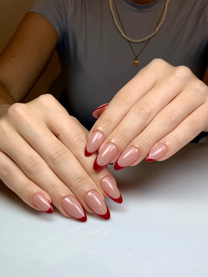 Portofolio soft gel tip Feta Beauty Studio — French tip merah bentuk almond